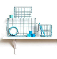 Set of blue Ocean baskets in varying sizes displayed on a white shelf for storage and organization