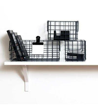 Set of slate-colored wire baskets for organizing small items on a shelf