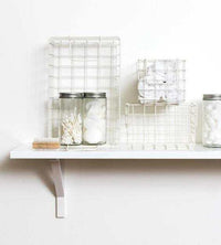 Set of chalk baskets in creamy white for organized storage on a shelf