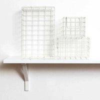 Set of chalk baskets in various sizes designed for locker storage, featuring a warm creamy white tone and wire grid design.