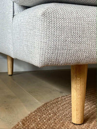 Close-up of Custom Norsu Sofa 2.5 seater leg and textured Wells Driftwood fabric upholstery