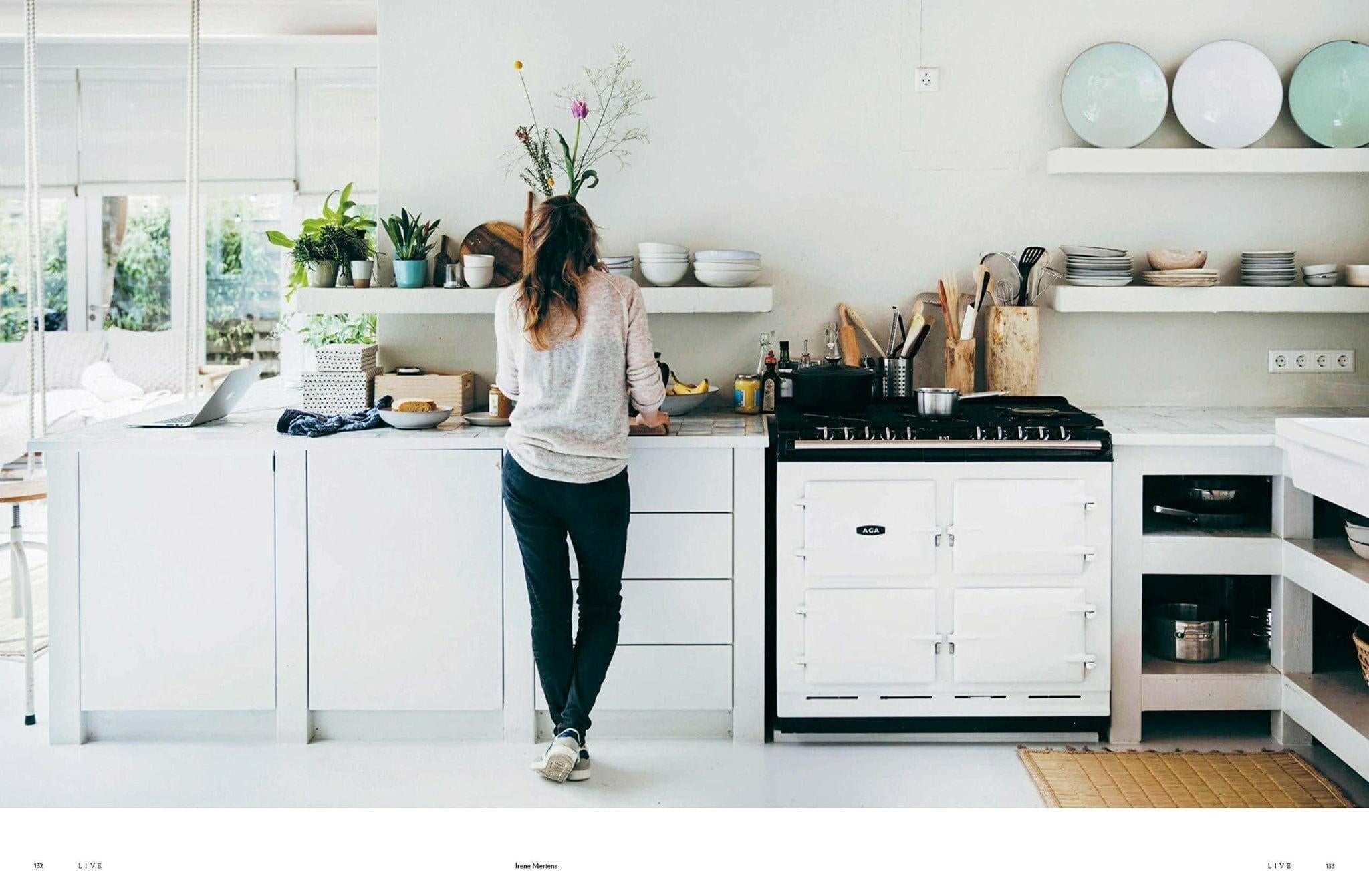 This Is Home book by Natalie Walton with woman in bright minimalist kitchen focusing on simple living and authentic home interiors