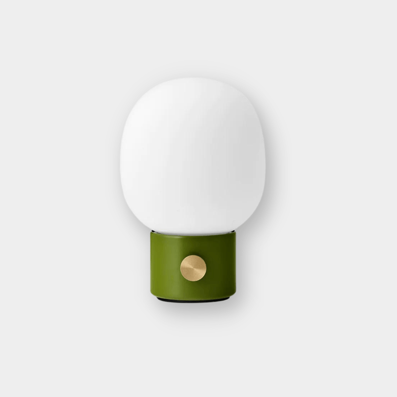Menu JWDA Portable Lamp in dusty green with brass dimmer, cordless design, and elliptical glass shade.