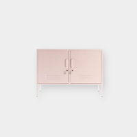 Blush pink Mustard Made Locker with double doors, handles, locks, and ventilation vents on slender legs.