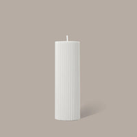 White cream Black Blaze wide pillar candle with vertical ridges, handmade and unscented, 15cm tall.